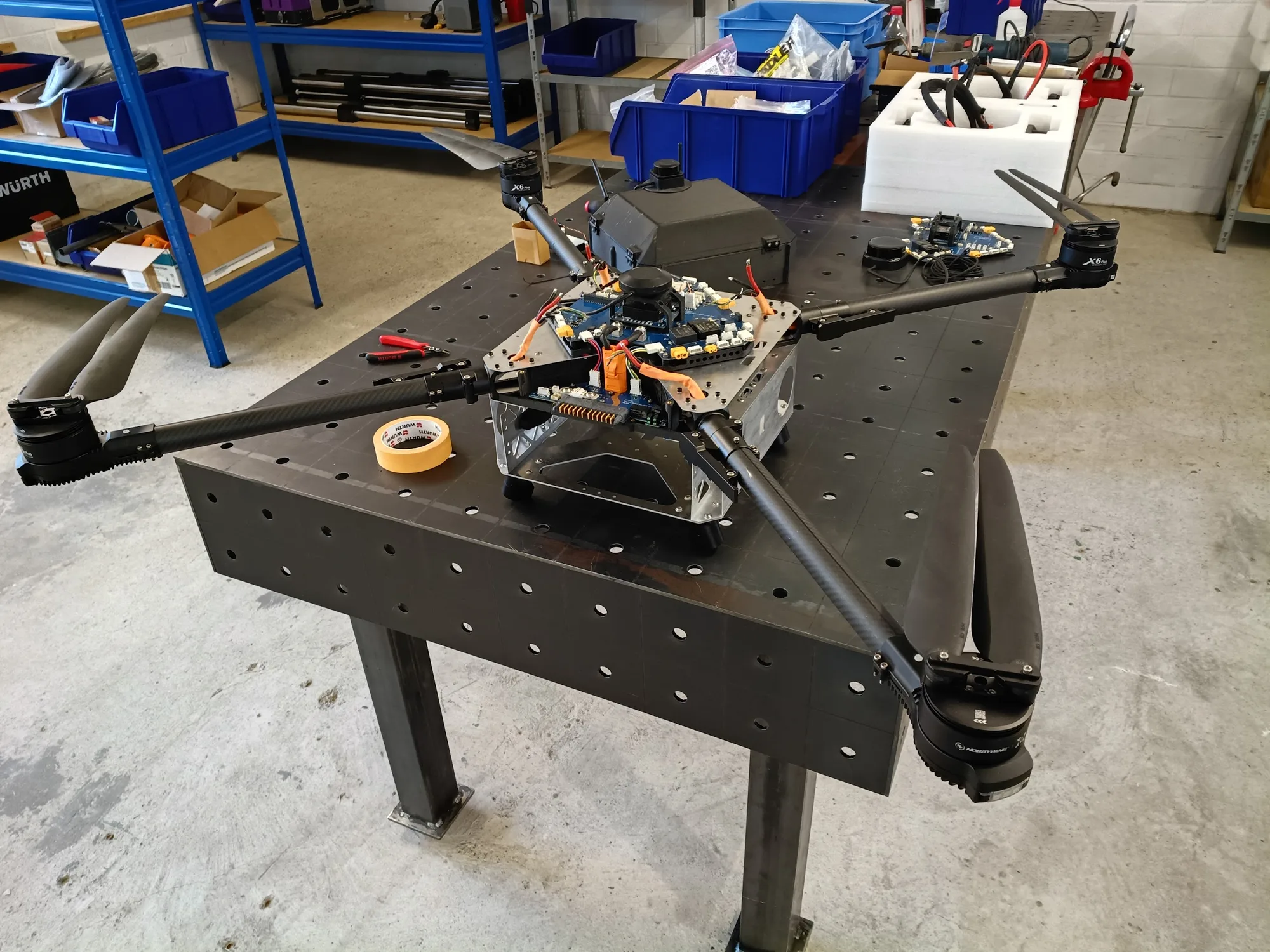 Quad on the workbench with avionics exposed